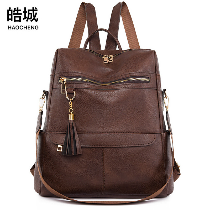 Spot al por mayor 2023 nuevo estilo coreano retro señoras mochila de viaje multifuncional de borla de cuero suave de moda