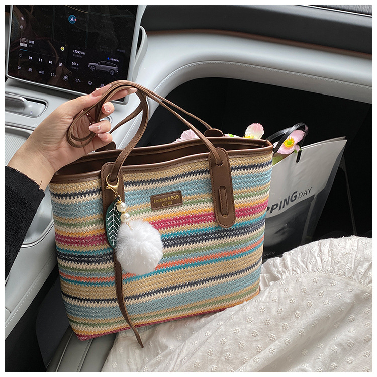This is a new 2025 summer beach-style women's bag with a simple and versatile hand-held design. It's a single-shoulder vacation woven bag undefined