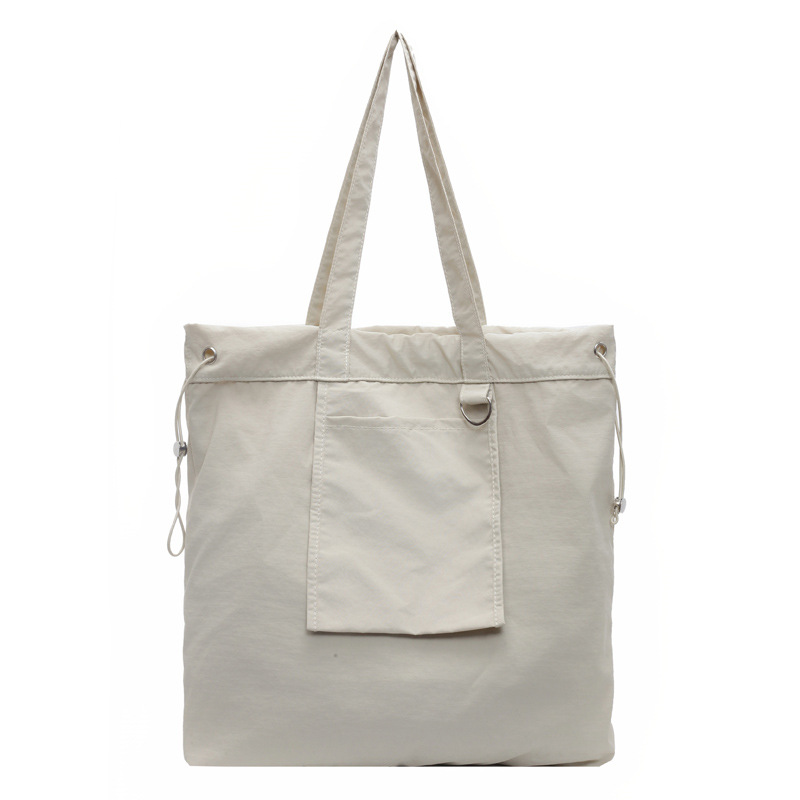 Bolsa de tela de nylon impermeable para mujeres 2025 nuevo tipo bolso de cubo de viaje ligero de gran capacidad bolso de hombro portátil para estudiantes universitarios