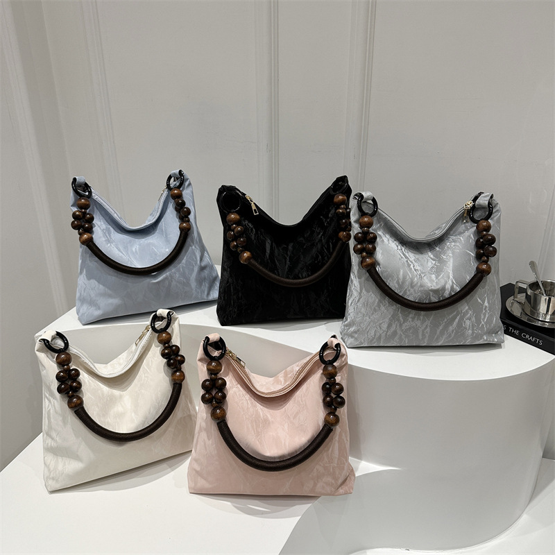 Nueva bolsa de estilo chino para mujeres 2024 verano nuevo estilo simple de moda seda bolso inferior nicho universal bolso de hombro casual