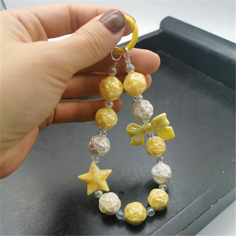 Colgante de estrella de cinco puntas con lazo amarillo