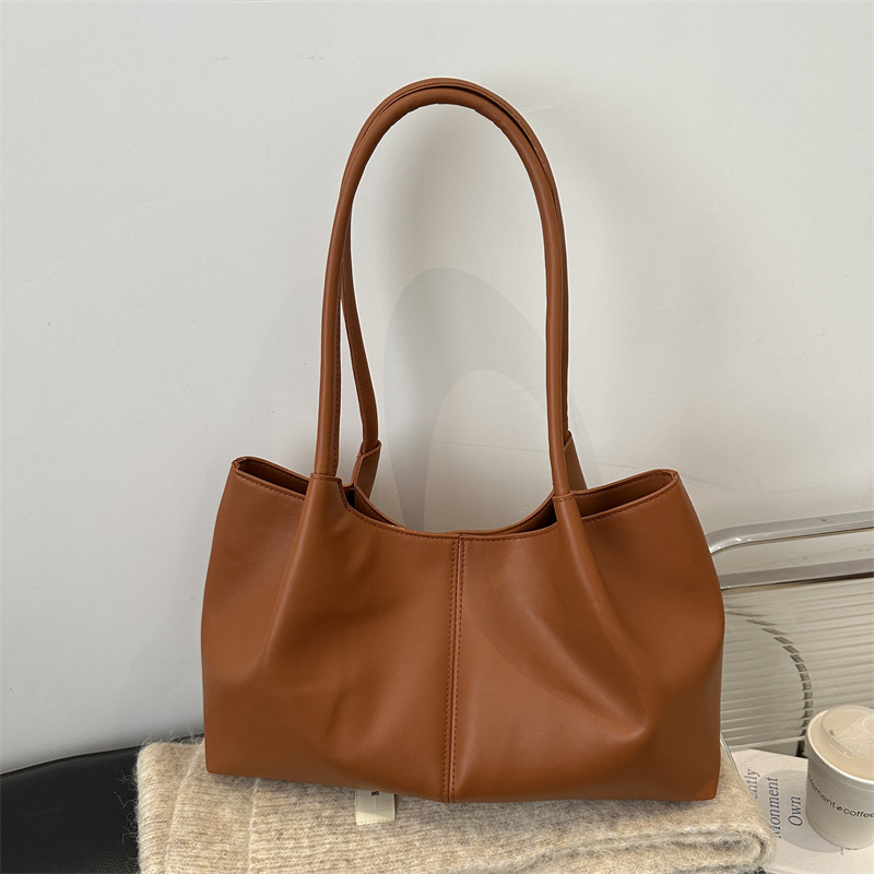 Este año, la sensación de relajación de la moda de color sólido 2024, el nuevo tipo de bolso de hombro simple de gran capacidad, bolso de mano de empalme de moda