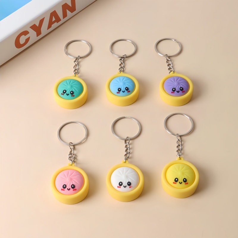 Popular Q-version small steamed bun keychain, made of soft PVC, featuring a cute smiling face design, perfect as an accessory or a charm for children's backpacks