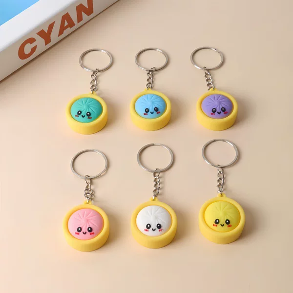 Popular Q-version small steamed bun keychain, made of soft PVC, featuring a cute smiling face design, perfect as an accessory or a charm for children's backpacks