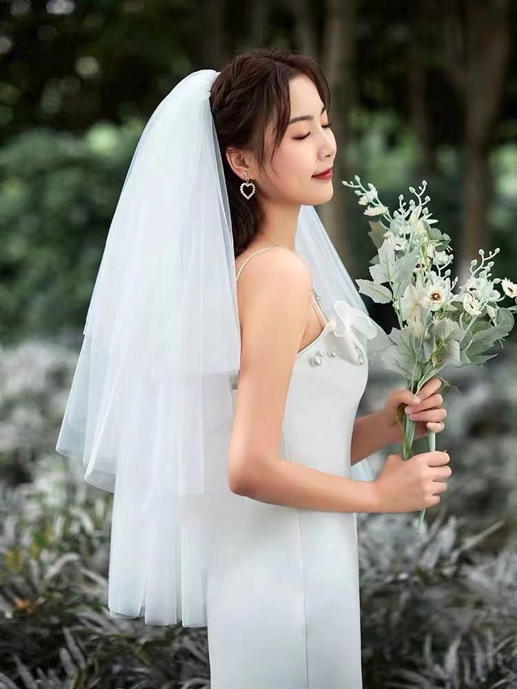 Multi-layered, voluminous tulle wedding veil for the bridal gown&mdash;perfect for elegant, mid-length, floor-length looks in sophisticated, minimalist style, ideal for travel-inspired photoshoots.