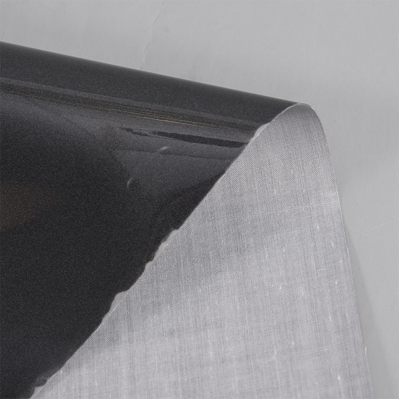 厂家风衣夹克用黑色反光布料服装夜光反光黑色面料 黑色反光TC布
