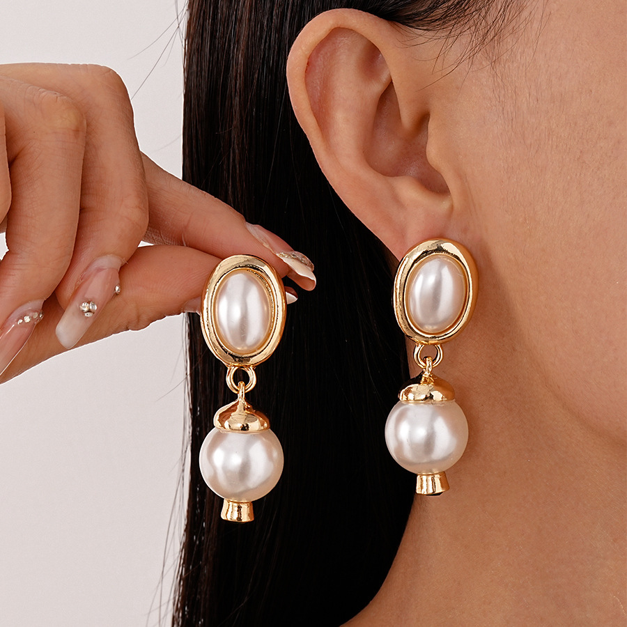 Pendientes de amor de perlas de lujo ligero con aguja de plata Pendientes de sentido de alta gama de temperamento de nicho Pendientes de estilo de palacio de todo fósforo de moda al por mayor