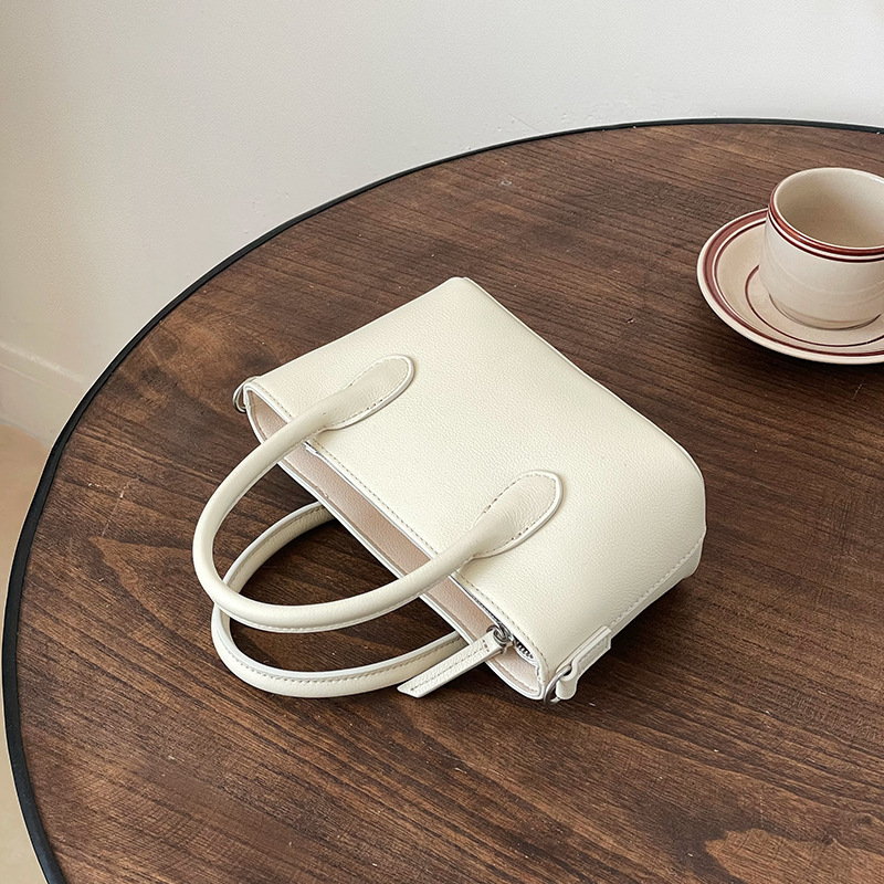 Mini bolsa de cesta de verduras de cuero minimalista 2025 nuevo estilo de piel de vaca Xiaozhong lingote bolso de mensajero portátil bolso de hombro femenino