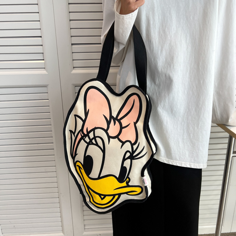 Bolsa de lona para mujeres versión coreana del pato Donald 2025 nueva tarjeta de ocio de gran capacidad bolsa de compras para mujeres de mano