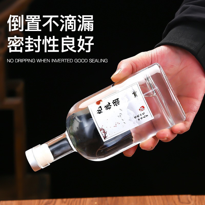 Botella de vidrio de vodka de alta calidad botella de vino de fruta cristal transparente de arena blanca dividida botella vacía con película de retracción térmica en stock