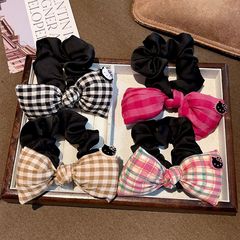 韓国の格子縞の蝶結びの小腸の輪の学院の風の少女は団子の髪のひものかわいいKittyの馬尾のひもを刺します。