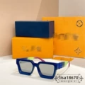 Dark blue frame light gray lenses green and pink color block temples