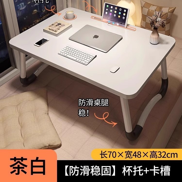 折り畳み可能なベッドの上の小さなテーブルは机のノートパソコンのテーブルを勉強します。|undefined