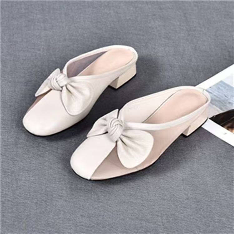 Zapatillas de piel suave de tacón bajo para mujeres primavera y verano 2026 nuevas zapatillas de tela plana para la cabeza de la bolsa para usar zapatillas de mujer