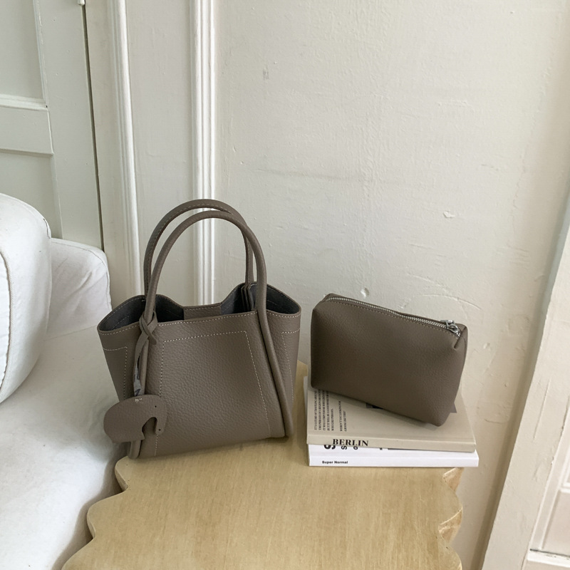 Bolso para mujeres 2026 nuevo estilo de moda bolso de cubo portátil de alta calidad lichi patrón popular lujo ligero mochila casual
