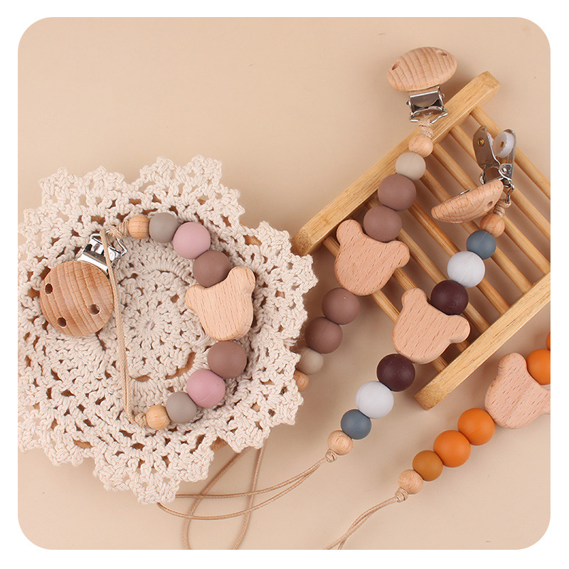 Productos para bebés y niños abrazadera de chupeta creativa caricatura bebé oso cabeza de beech mordida cadena de chupeta de dientes molares anti-caída cadena