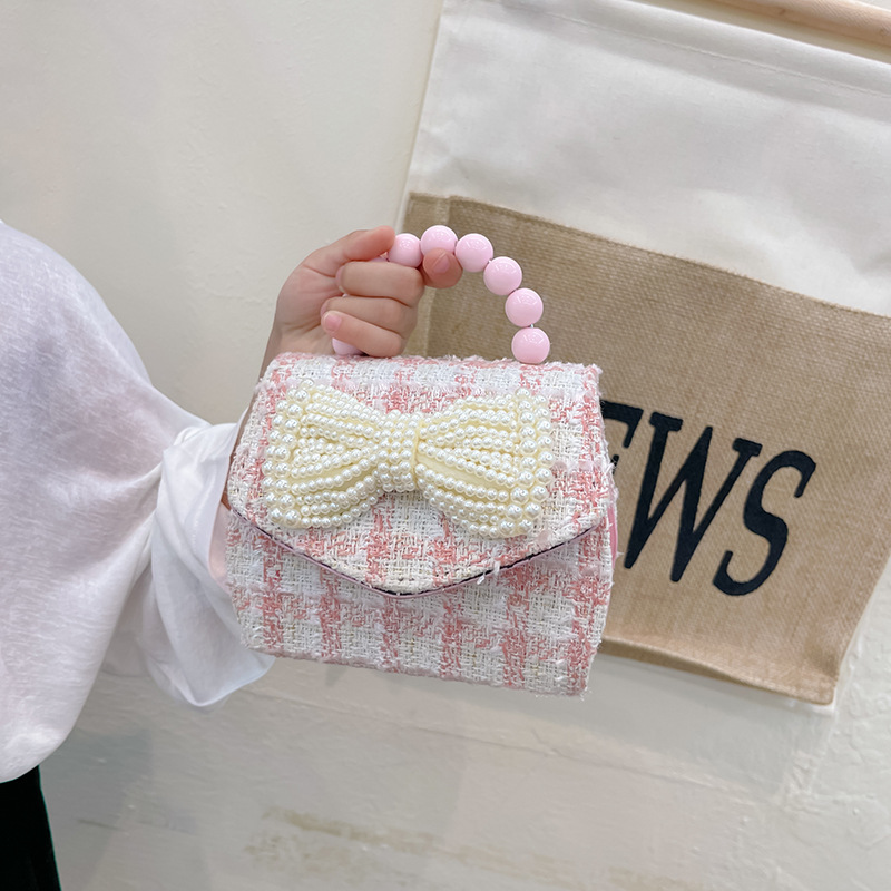 2022 nuevo arco de la celebridad en línea tejida bolso de los niños de las mujeres de estilo coreano lindo crossbody mini bolso de la perla