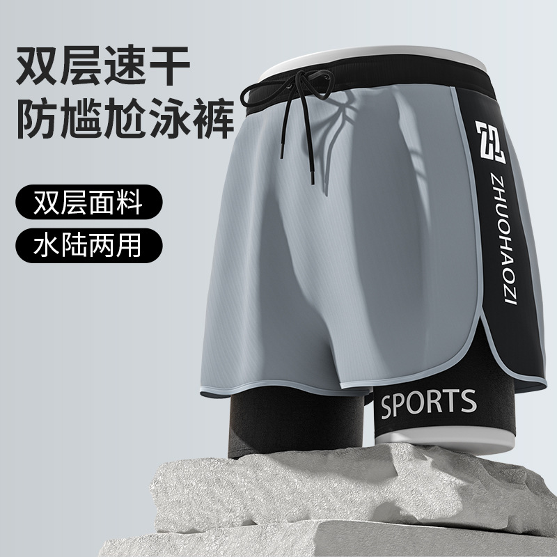 Trajes de baño de primavera 2025 al por mayor para hombre, anti-embarrassment, de doble capa, sueltos, de playa, de cinco puntos.