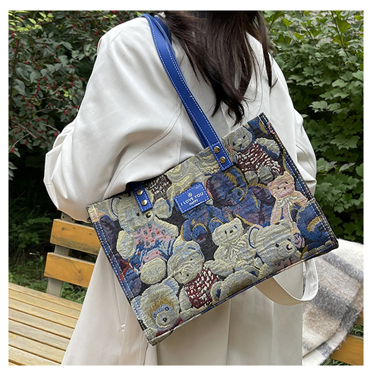 Bolsa de lona impresa de dibujos animados para mujeres 2024 nueva bolsa de gran capacidad, bolsa de hombro de viaje casual versátil