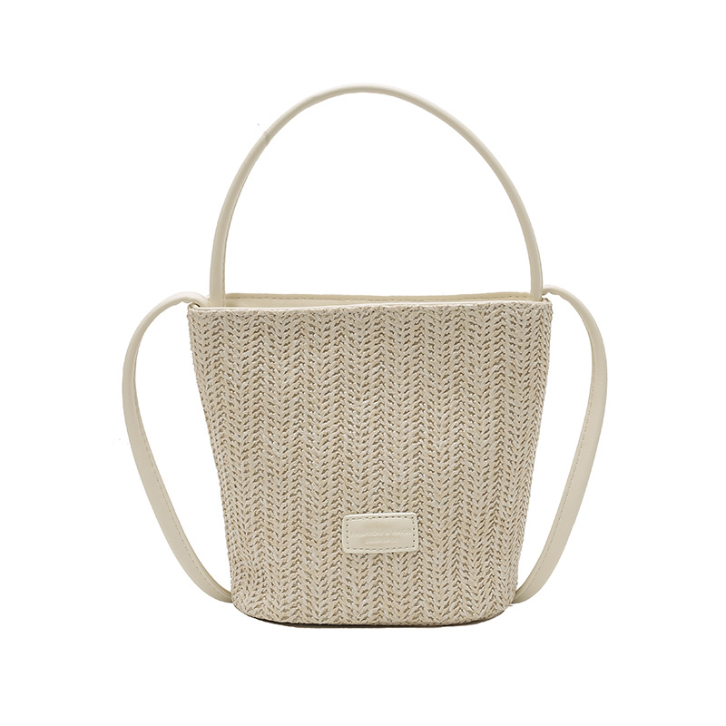 Bolso de cubo de vacaciones junto al mar 2025 nuevo bolso de mujer bolso de hombro tejido de paja de playa bolso de mensajero de color de contraste a rayas