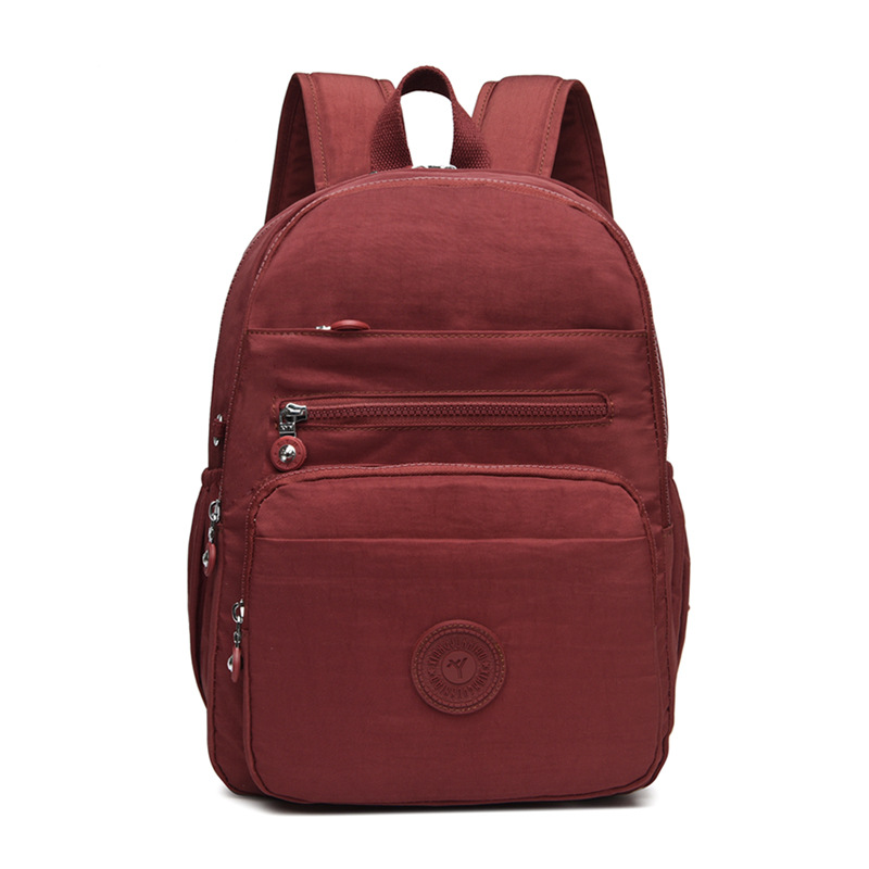 Mochila de hombro de comercio exterior 2025, nueva mochila de computadora simple de color sólido, mochila de escuela secundaria, mochila para hombres y mujeres.