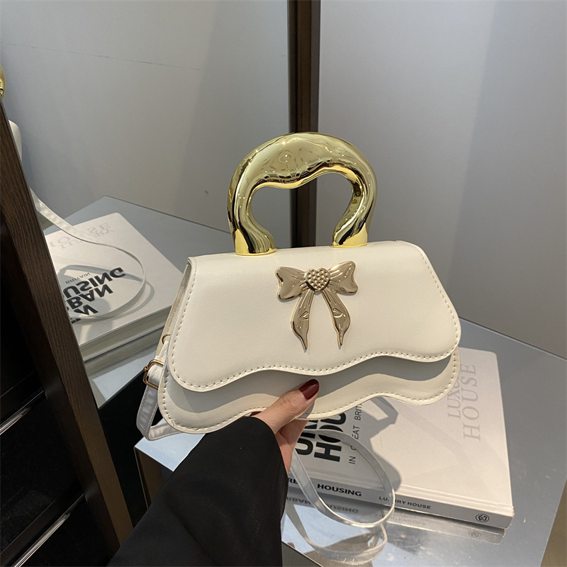 Bolso de arco ondulado damas 2024 nuevo otoño invierno bolso de hombro color caramelo estilo extranjero bolso de mochila elegante