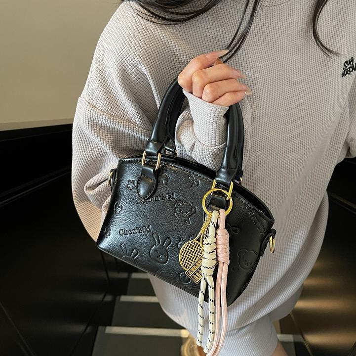 Tendencia nicho bolso de mano de moda mujer 2025 nueva textura versátil bolso de cubo bolso de transporte aéreo