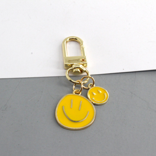 European and American cross-border new cartoon smiley face keychain fashion dripping oil color large and small smiley face pendant girl heart pendant