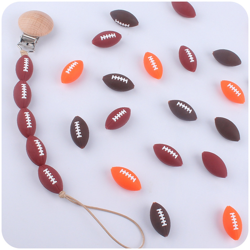 Creativo DIY suministros de bebé de dibujos animados de silicona rugby mordedura de bebé mordedura molar cadena de chupete accesorios