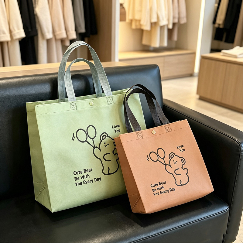Customized non-woven fabric tote bag with hidden snap button, high-end eco-friendly packaging bag for clothing stores, commercial fashion bear bag Customized non-woven fabric tote bag with hidden snap button, high-end eco-friendly packaging bag for clothing stores, commercial fashion bear bag