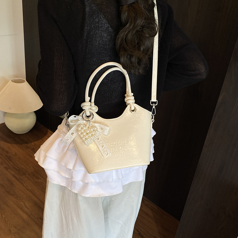 Bolso de mano de estilo occidental de ocio para mujer 2025 nuevo producto de moda de cercanías bolso de mensajero de un solo hombro de todo fósforo bolso de cubo de cuero de cera de aceite