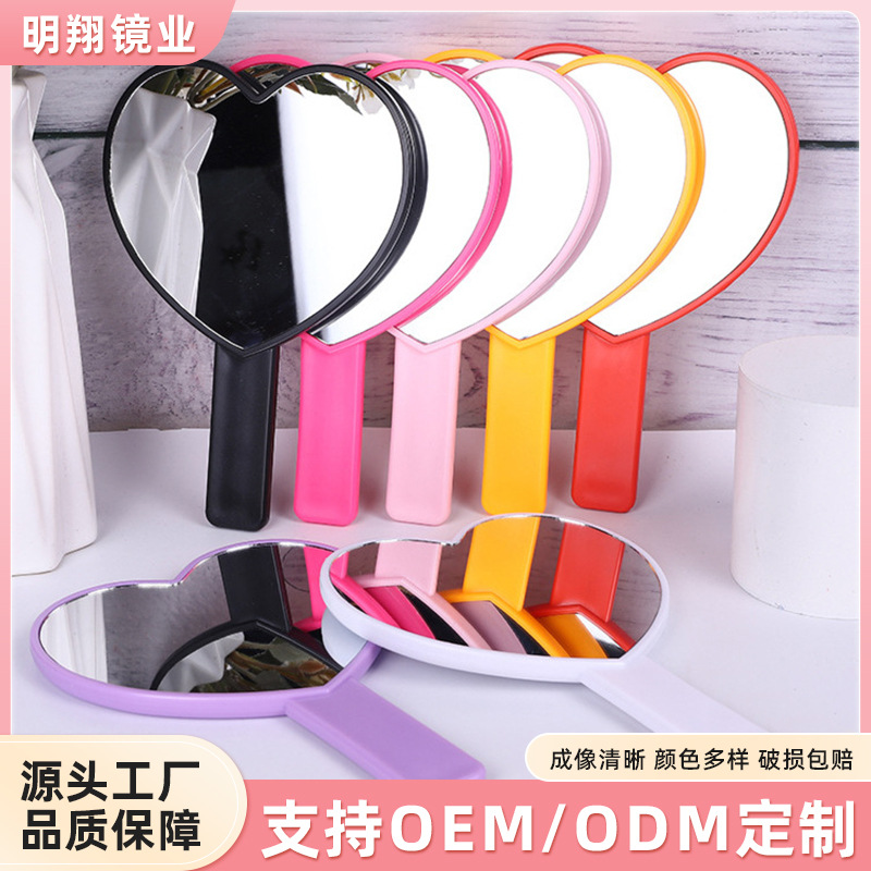 Venta al por mayor Chicas lindo en forma de corazón espejo de maquillaje portátil conveniente espejo de mango simple irregular espejo de vestidor de un solo lado