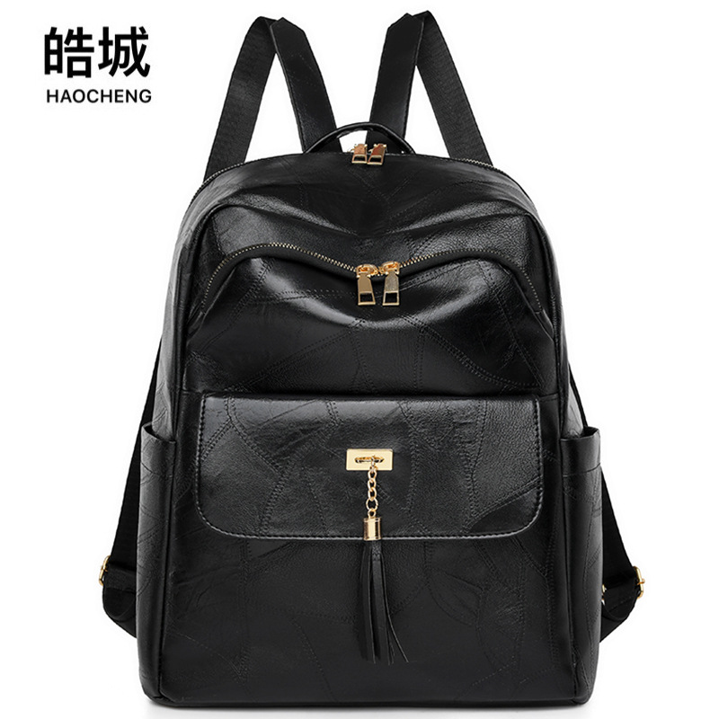 Comercio exterior al por mayor 2024 nueva mochila de PU para mujer retro simple y versátil color sólido de gran capacidad mochila para exteriores marea