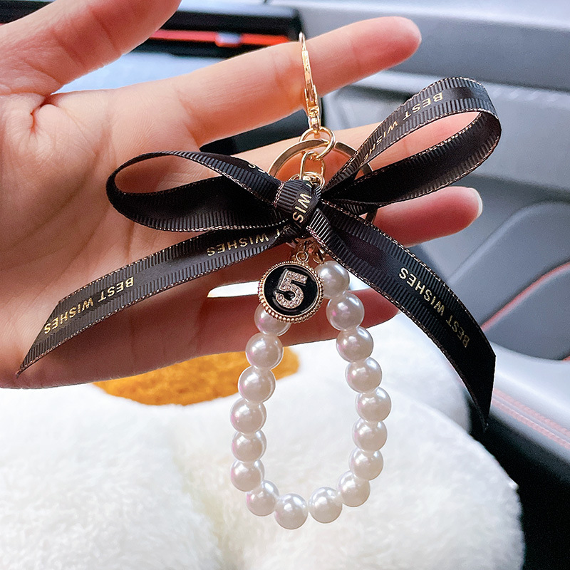 Nuevo simple llavero de arco de perla pequeño bolso colgante de automóvil interior colgante al por mayor