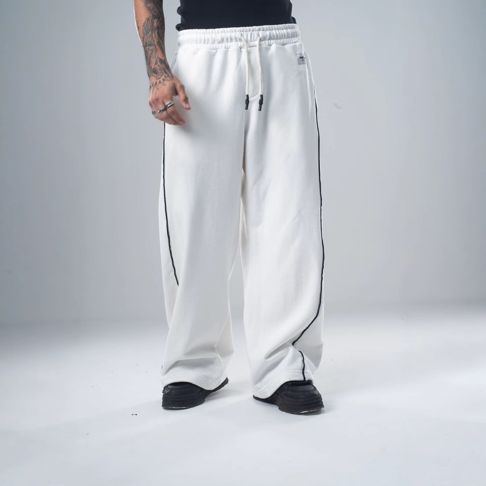 Pantalones deportivos casuales versátiles de pierna recta para otoño e invierno 2025, pantalones holgados retro de moda con costuras laterales de patchwork para hombre.