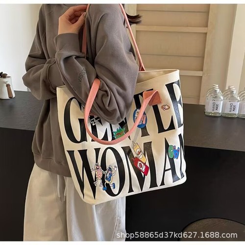 Autumn and winter large-capacity bucket bag for women, 2025 new style, niche cartoon canvas tote bag, college student's shoulder tote bag