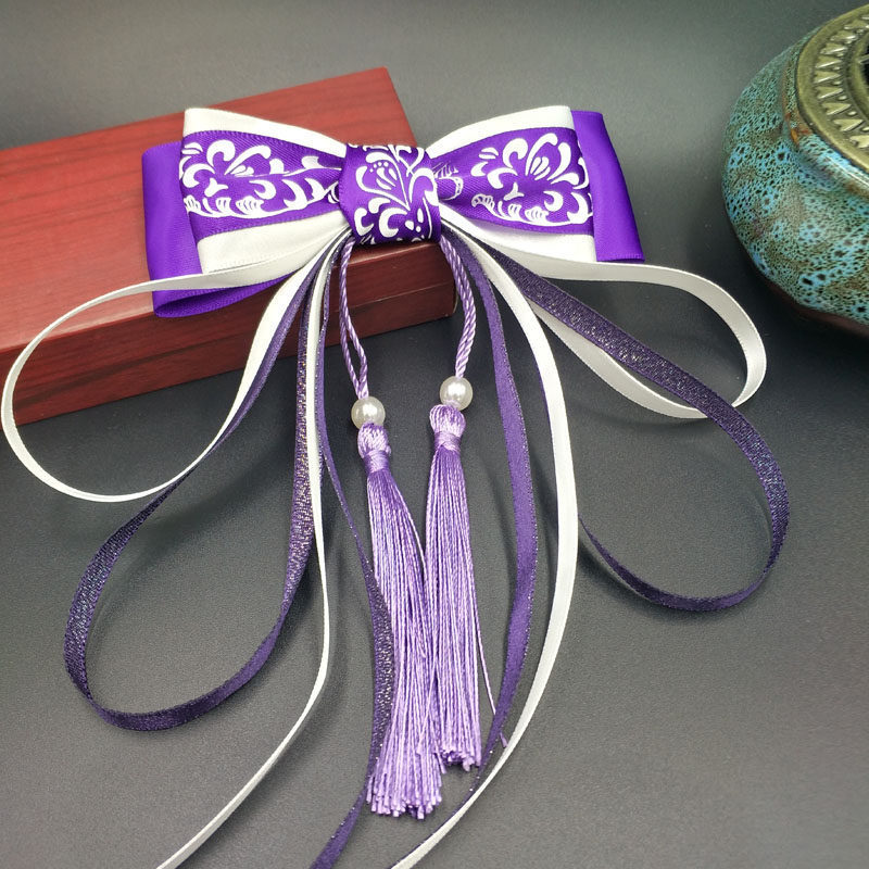 Blue and white hairgrip with tassels