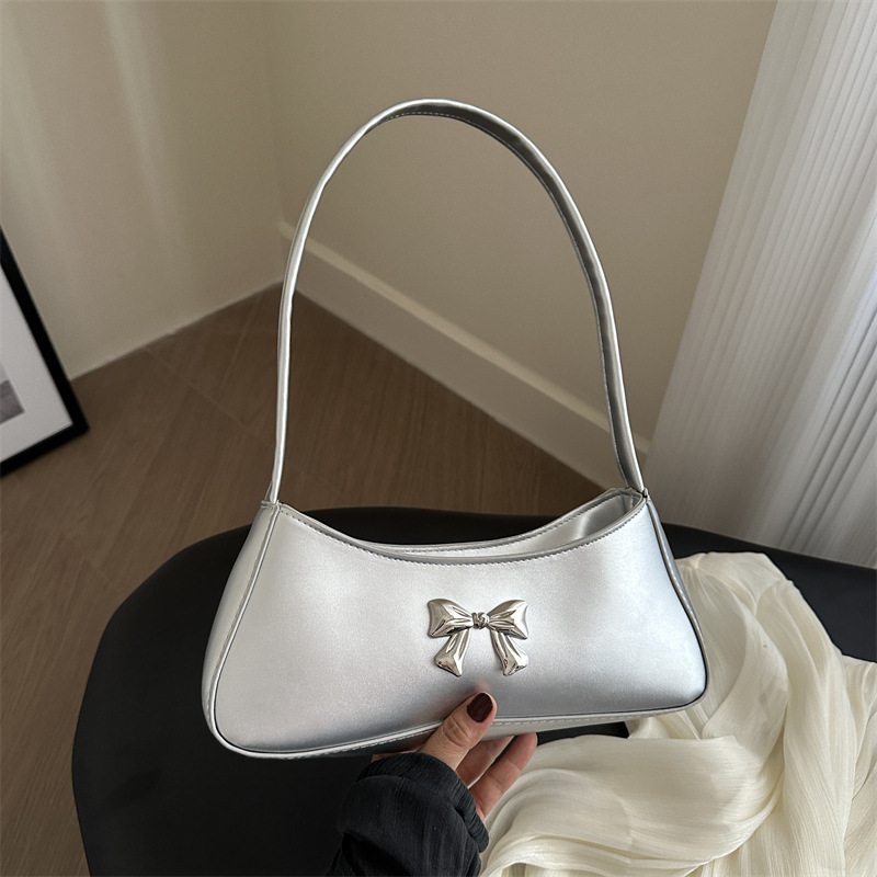 Bolsos axilales de alta textura 2024 verano nuevo diseño de moda francesa temperamento simple arco bolso de hombro