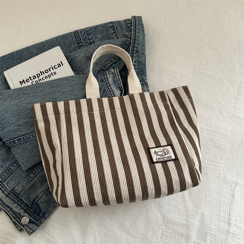 Bolso tote de tela a rayas de estilo europeo y americano, nuevo bolso pequeño de moda, bolso femenino portátil, bolso de almuerzo de mano, bolso de bocadillos