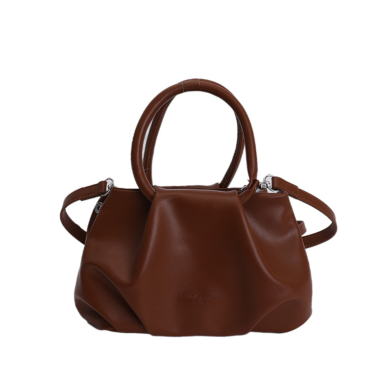 Alta sensación de mano pliegueada nube bolso de cubo para mujeres 2026 nuevo nicho de lujo ligero de moda perla bolsa de mochila