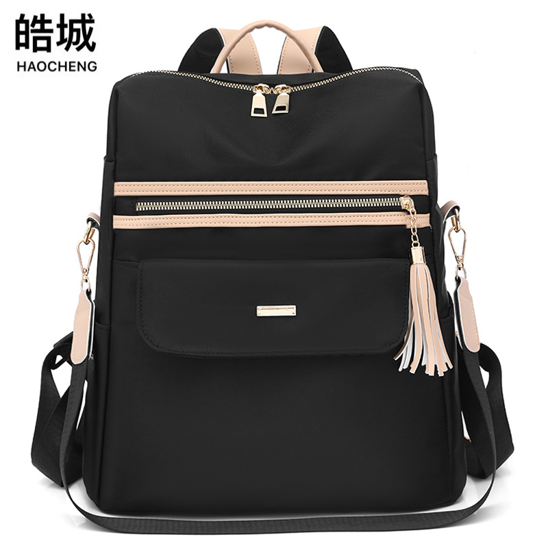 2023 nueva mochila de tela Oxford para mujer casual moda contraste color borla mochila de gran capacidad marea al por mayor