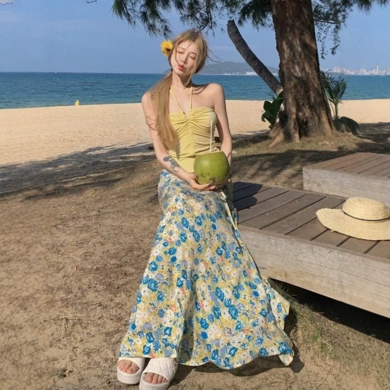 Outfits for Women for Seaside Vacations in Thailand: Yellow Halter Neck Tank Top Paired with Floral Print Skirt Two-Piece Set