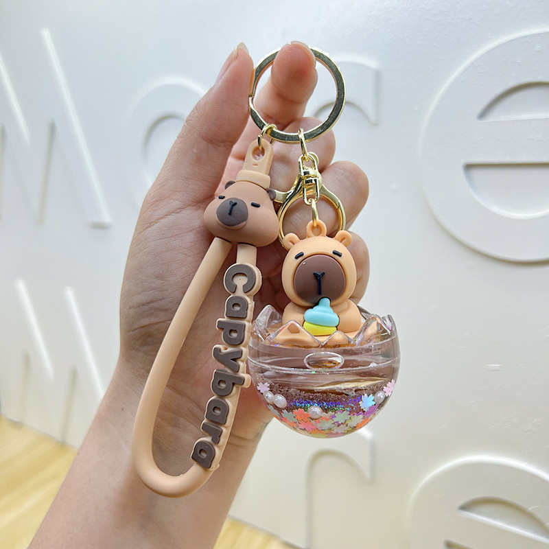 Cariño interesante en el aceite muñeca Kapibara llavero lindos colgantes delfines bolsa de automóvil garra máquina pequeños regalos al por mayor