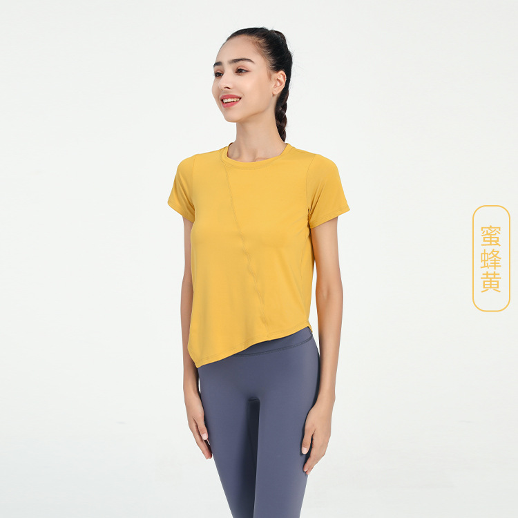 Nuevo verano suelto fitness deportes de manga corta Camiseta de mujer de color sólido europeo y americano de secado rápido irregular yoga Top blusa