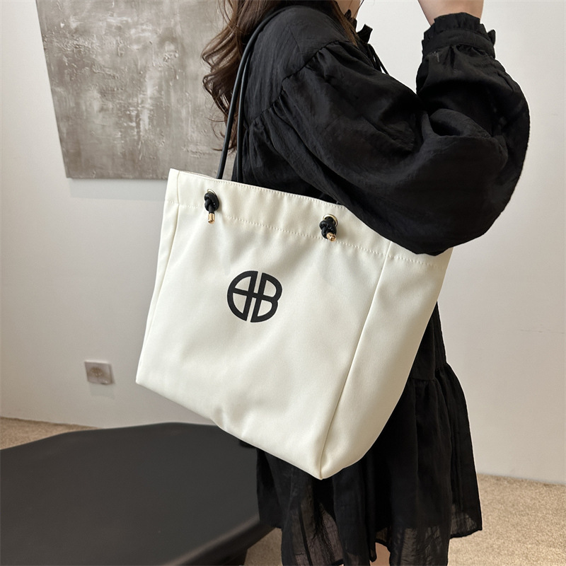 Bolsa de lienzo de gran capacidad de letras para mujeres este año nueva bolsa de hombro de moda universal bolsa de viaje bolsa de mano bolsa de mamá