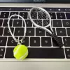 Silver tennis racket + green ball