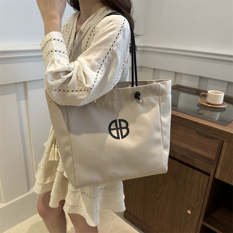 Bolsa de lienzo de gran capacidad de letras para mujeres este año nueva bolsa de hombro de moda universal bolsa de viaje bolsa de mano bolsa de mamá