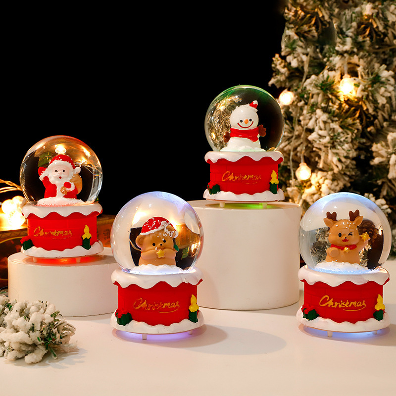 Una variedad de bolas de cristal luminosas de dibujos animados lindos creativos, adornos decorativos explosivos, regalos navideños, bolas de cristal con luz al por mayor