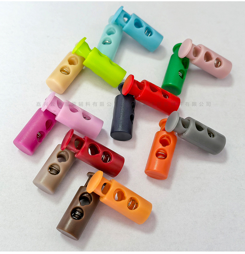 Kunststoff-Farbfedern-Schnallenverschluss, zweilöchrige zylindrische Seilschnalle, Daunenjacken-Verstellschnalle, Elastic-Stopper, Rutschfester Verschluss, Glockenform-Schnalle