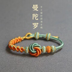 曼荼羅は桃の花の手の縄の女性の男性の手編みのブレスレットの子供を結びます。
